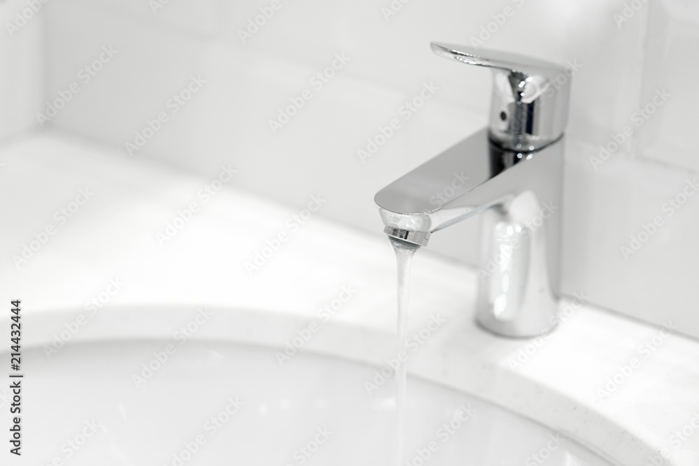 chrome crane on the ceramic wash basin in the bathroom close up chrome crane on the ceramic wash basin in the bathroom close up