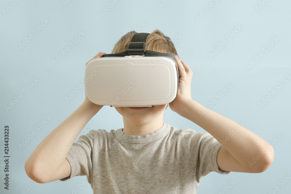 Boy with glasses of virtual reality. Blue background Boy with glasses of virtual reality. Blue background