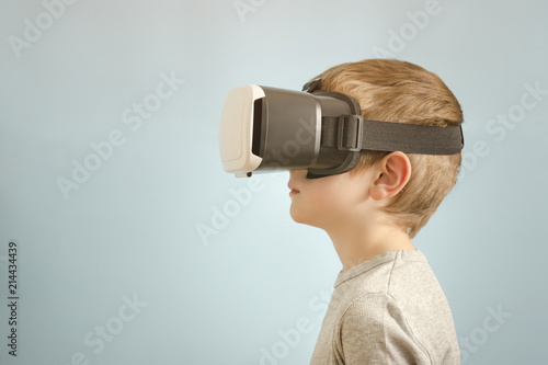 Boy with glasses of virtual reality. Blue background
