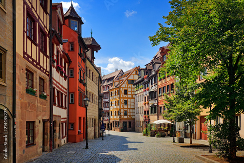 Street in Nuremberg. Half-timber work on the facade of wooden buildings in the German city of Nuremberg, Bavaria. Traditional architecture 'Fachwerkhaus' Timber framing Horizontal view, stone paving.