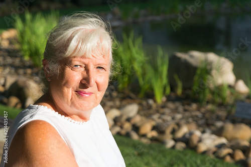 Portrait of a white haired lady looking at the camera