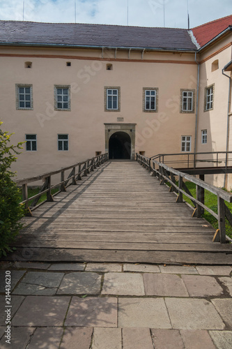 Wooden bridge with railing to the arch of the entrance to the castle. Transcarpathia Uzhhorod Ukraine