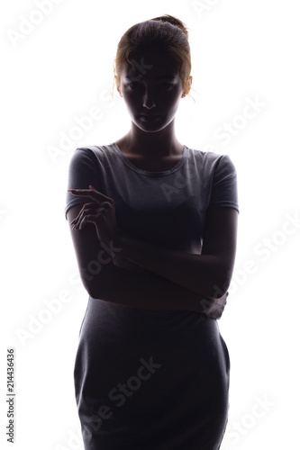 silhouette of confident young woman looking straight on a white isolated background