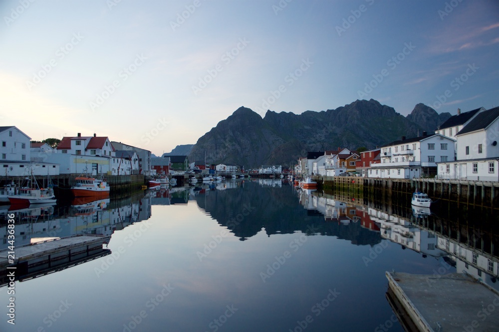The colorful arctic village of Henningsvaer with its famous reflections in Norwegian Lofoten islands, Norway