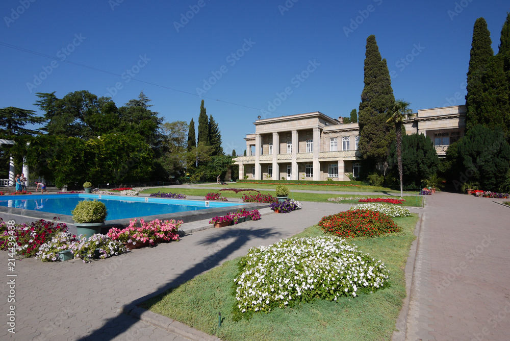 a swimming pool with clear clear water in the park and many beautiful flowers around it