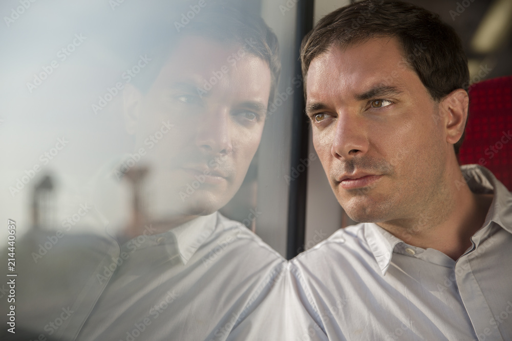 Man looking pensively thorough window Man looking pensively thorough window