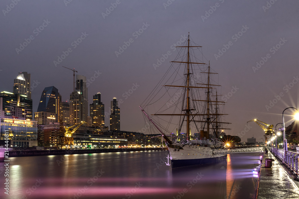 The old ship is on the dock at sunset. Reflectin in thr river.  Buenos Aires, Argentina. South America. Long exposure photography
