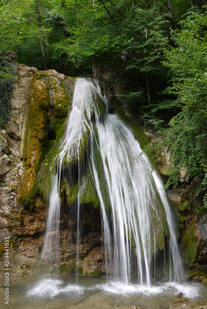 Beautiful scenic big waterfall against the backdrop of stone rock and green plantations Beautiful scenic big waterfall against the backdrop of stone rock and green plantations