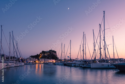 Denia Marina at sunset, with the famous medieval castle on the background. Alicante, Spain. photo