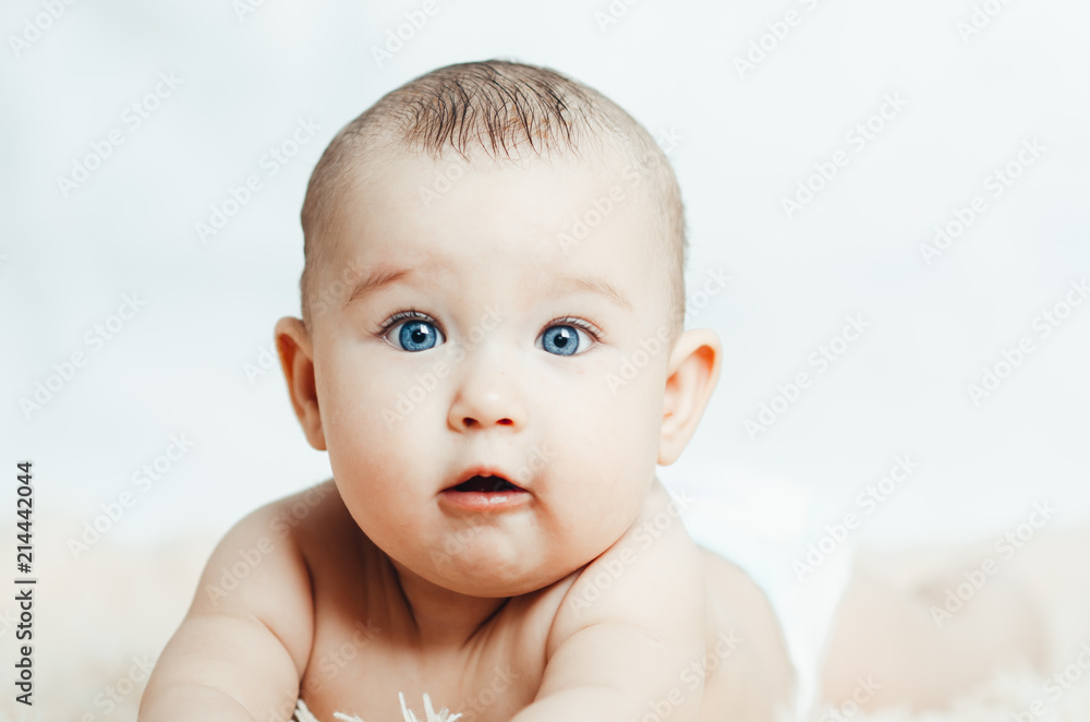 Small smiling baby with a toy Small smiling baby with a toy