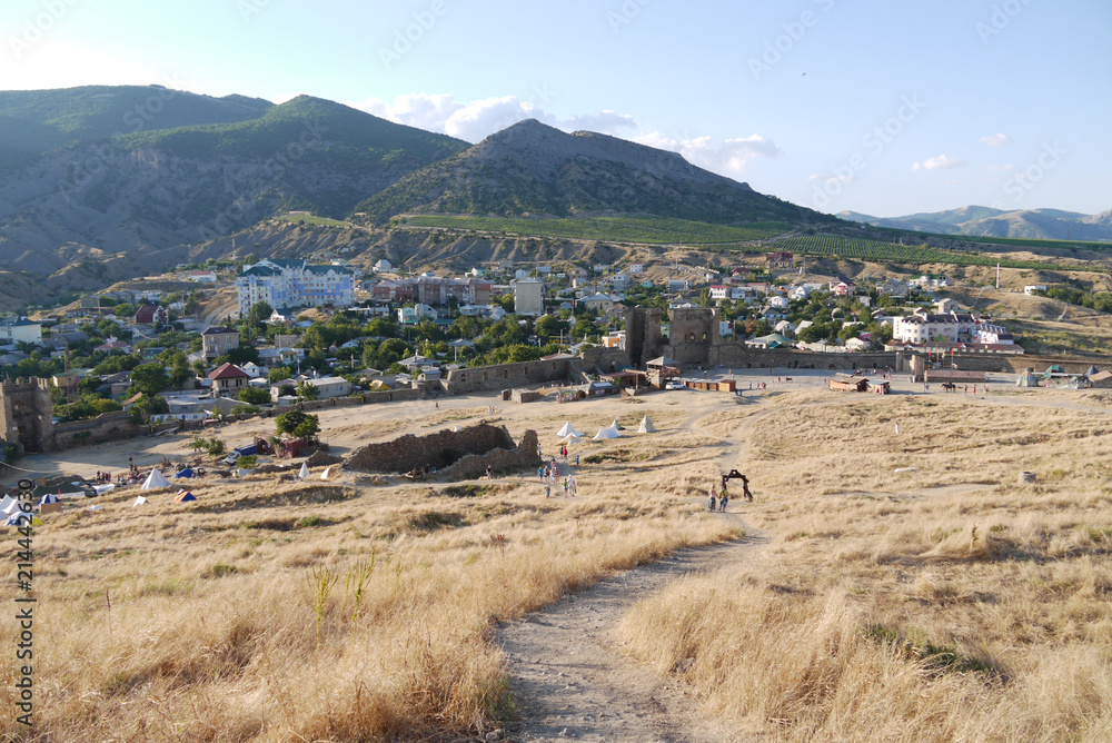 Archaeological excavations on the ruins of the castle near the town on the background of the mountains Archaeological excavations on the ruins of the castle near the town on the background of the mountains