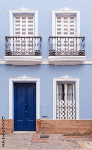 pastel blue tenement that with stylish windows and doors