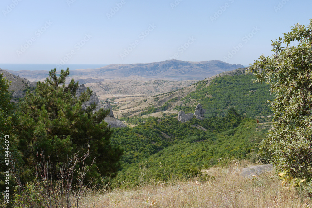 landscape of dry mountain ranges in front of the sea gulf in the distance