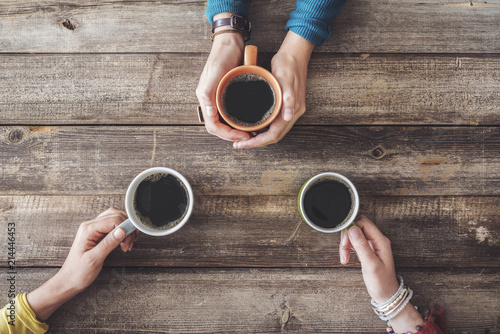 People hands holding a cup of coffee