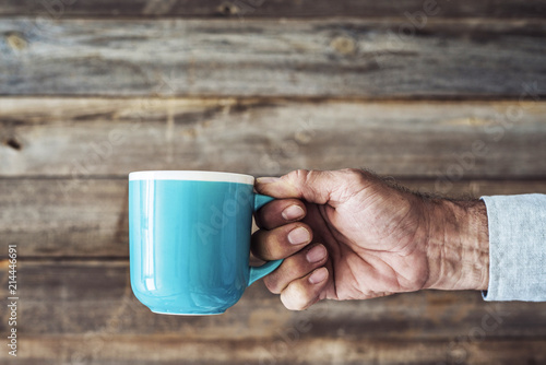 Man hand holding a cup of coffee