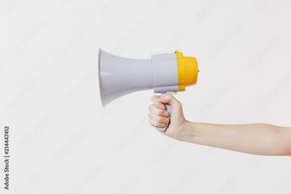Close up female holds in hand bullhorn public address megaphone isolated on white background. Hot news, announce discounts sale, communication concept. Copy space. Advertising area. Close up female holds in hand bullhorn public address megaphone isolated on white background. Hot news, announce discounts sale, communication concept. Copy space. Advertising area.
