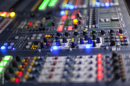 music, technology, people and equipment concept - hands using mixing console in sound recording studio
 photo