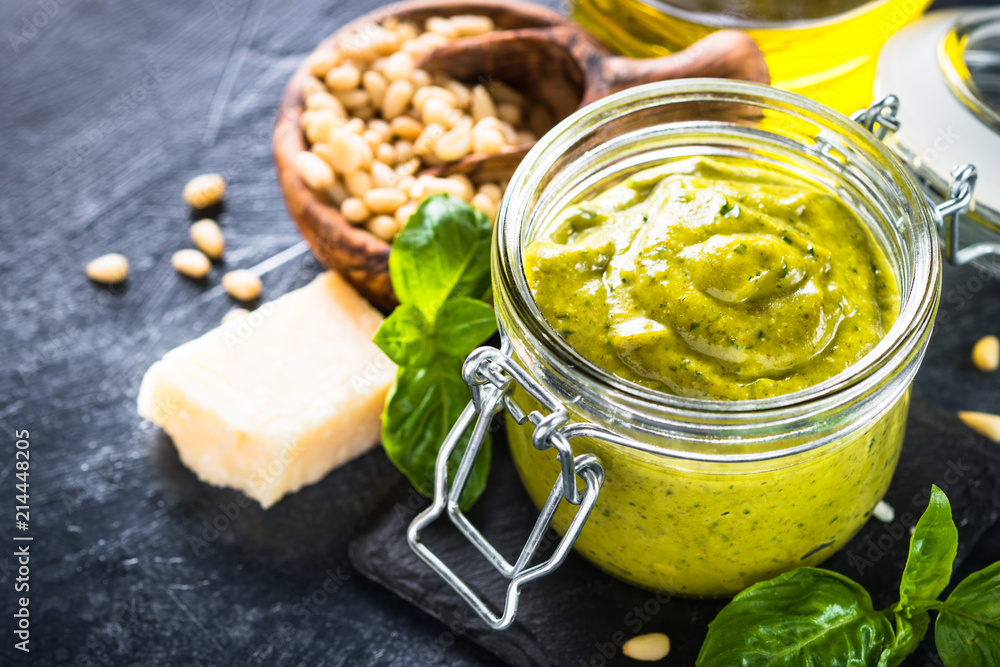 Pesto sauce with ingredients on dark stone table. Pesto sauce with ingredients on dark stone table.