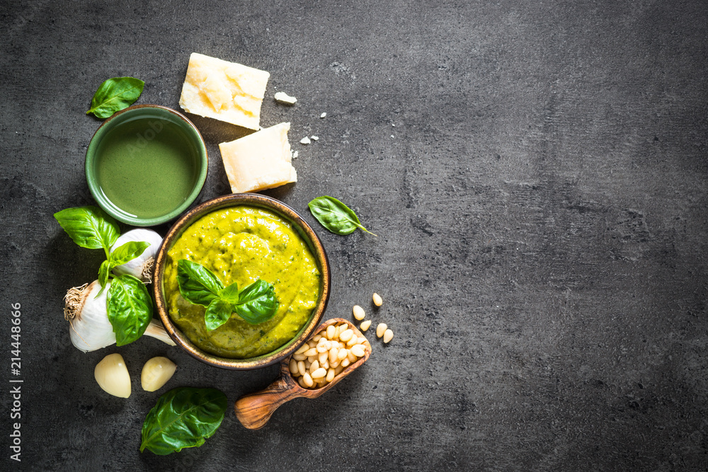 Pesto sauce with ingredients on dark stone table. Pesto sauce with ingredients on dark stone table.