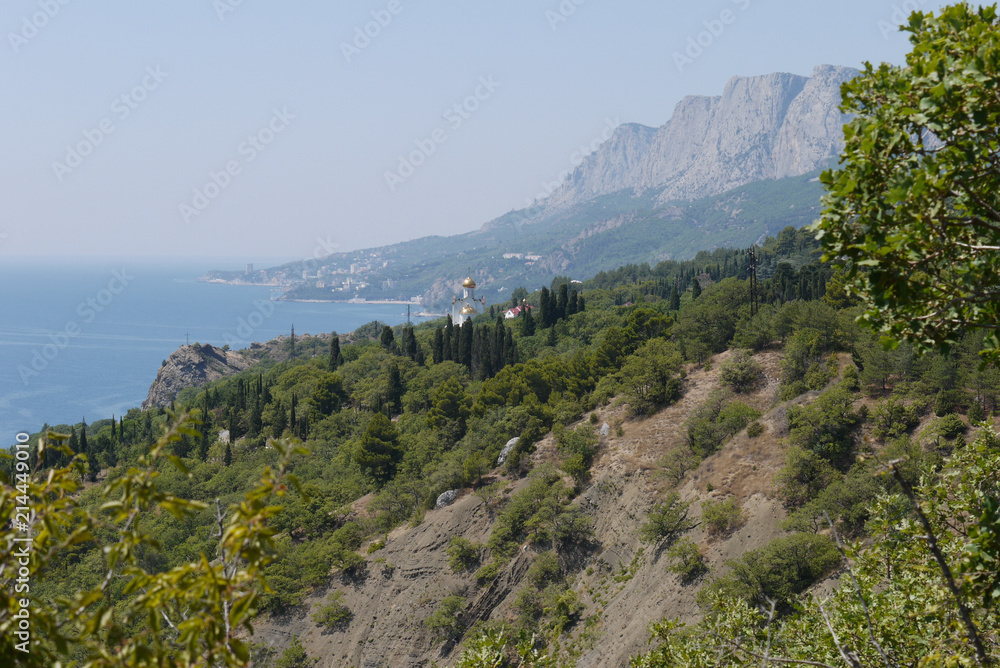 Obraz premium grass slopes on the background of high steep cliffs and the boundless black sea
