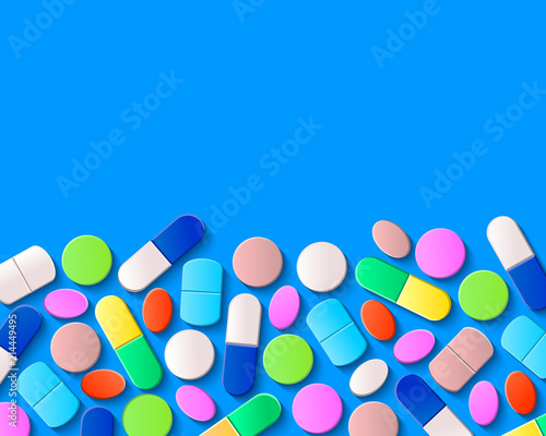Various pills, tablets and capsules on blue background. Pharmaceutical medicine concept.