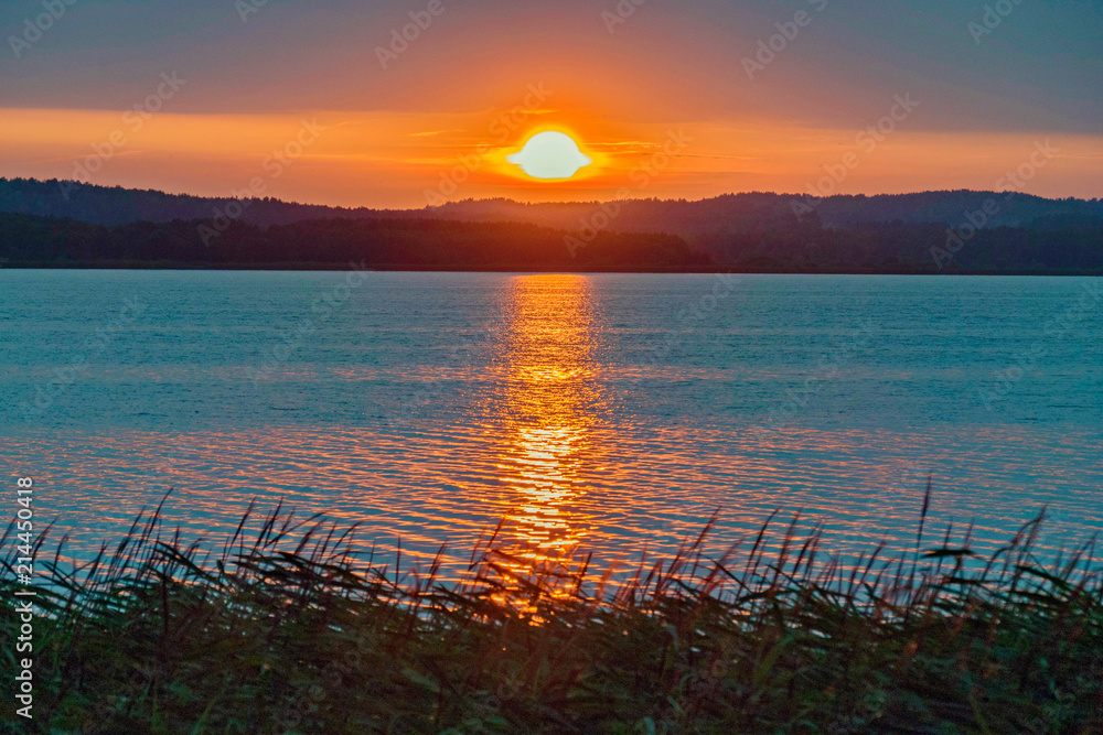 Naklejka premium calm sea on the background of a beautiful fire sunset