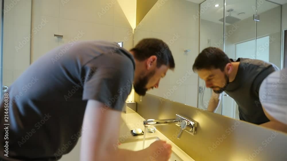 man washed his face, looked at himself in the mirror and left the bathroom man washed his face, looked at himself in the mirror and left the bathroom