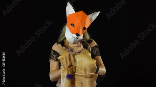 Blonde Girl with Fox Mask paper Using Pig Skin for Covering. Black Background. 4k UHD photo
