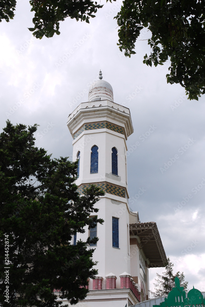 High rectangular eastern building with oblong windows and ornaments against the blue sky High rectangular eastern building with oblong windows and ornaments against the blue sky