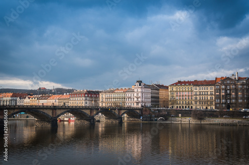 Palacky bridge over Vltava river in Prague, Czech Republic. Buildings and cloudy sky in the background. Space in the top side © kviktor