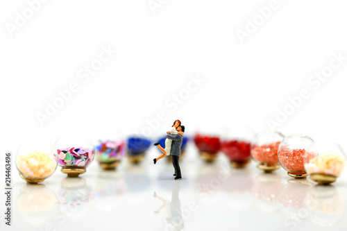 Miniature people : couple of love with Colorful of candies and lollipops,Lover and food concept.