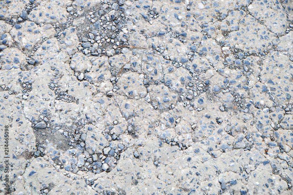 Cracked concrete with small rock textured background Cracked concrete with small rock textured background