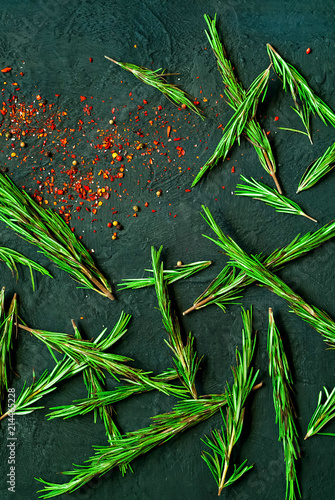dark creative background of fresh rosemary and spices.Healthy food, vegan or diet nutrition concept, natural light, copy space, closeup,