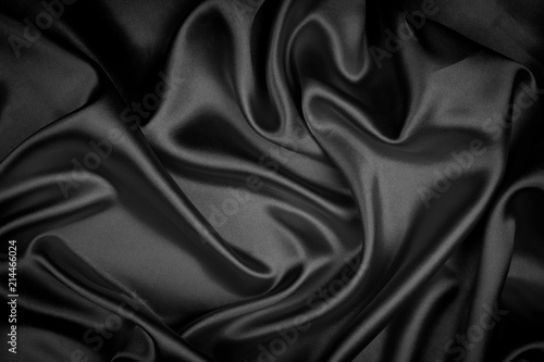 Black silk texture luxurious satin for abstract background. Fabric of dark tone