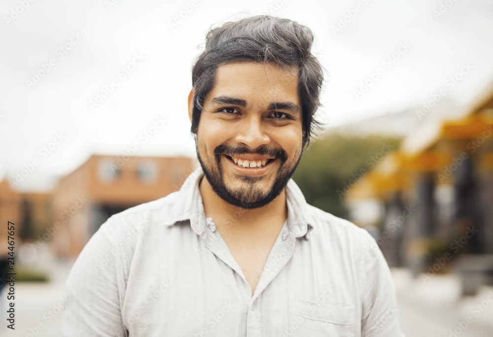 Attractive brunette latin man looking at the camera and smiling. Attractive brunette latin man looking at the camera and smiling.