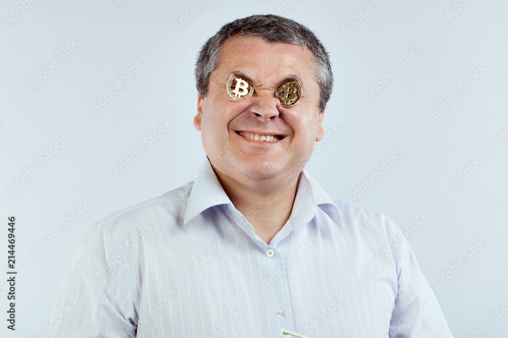 Businessman with bitcoins in his eyes smiling broadly. Businessman with bitcoins in his eyes smiling broadly.
