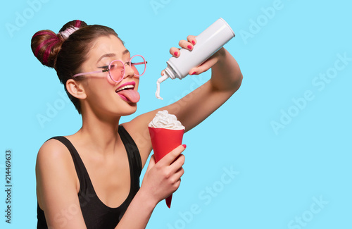 Φωτογραφία Fancy girl pressing whipped cream in red paper can