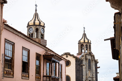 Churchtowers of Iglesia de Nuestra Senora de la Concepcion, the Church of La Concepcion behind buildings, Orotava, Tenerife, Spain photo