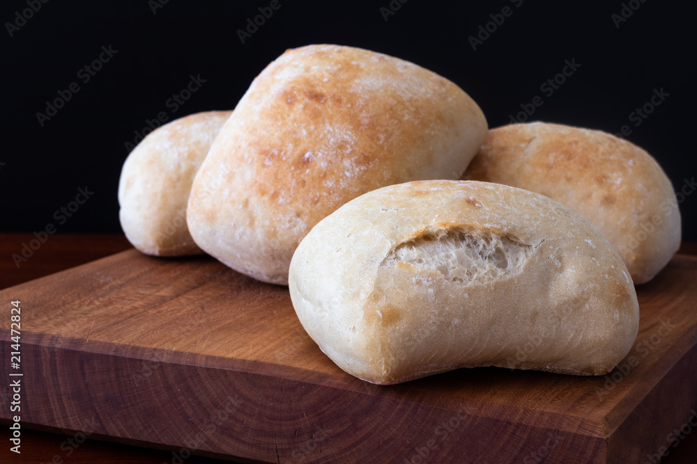 white bread rolls on a wooden board