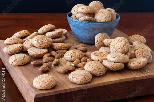 Amaretti biscuits on a wooden board with almonds