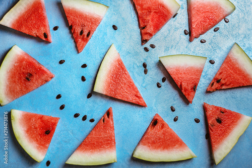 Watermelon slices on a  blue rustic wooden  background, flat lay
