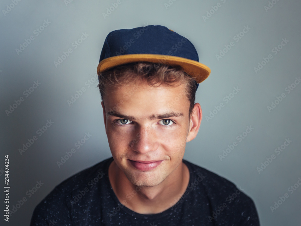 Portrait of a smiling casual teenage boy in blue cap Portrait of a smiling casual teenage boy in blue cap