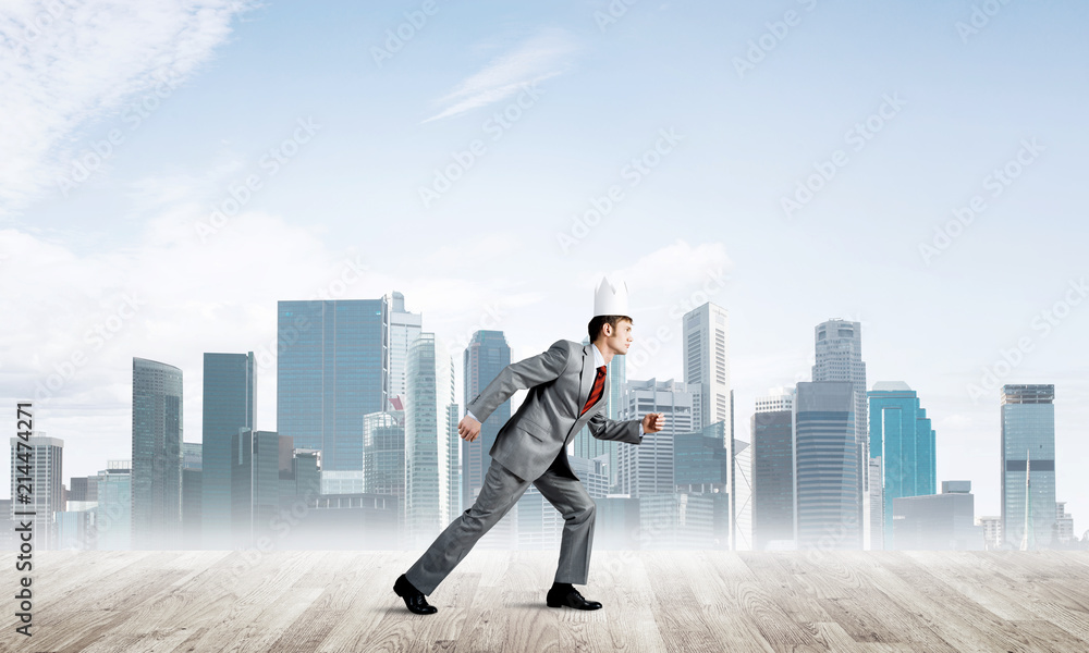 King businessman in elegant suit running and modern cityscape at background