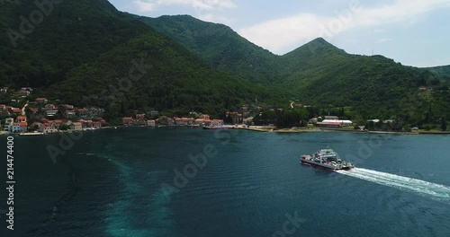 Aerial beautiful view from above to Kotor Bay and regular passenger ferry from Lepetane to Kamenari by a sunny afternoon photo