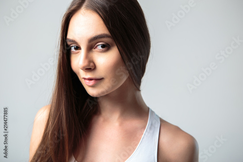 Simple portraits of beautiful young woman with natural makeup and long brown hair