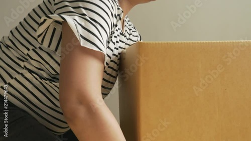 pregnant asian woman carry boxes for moving photo