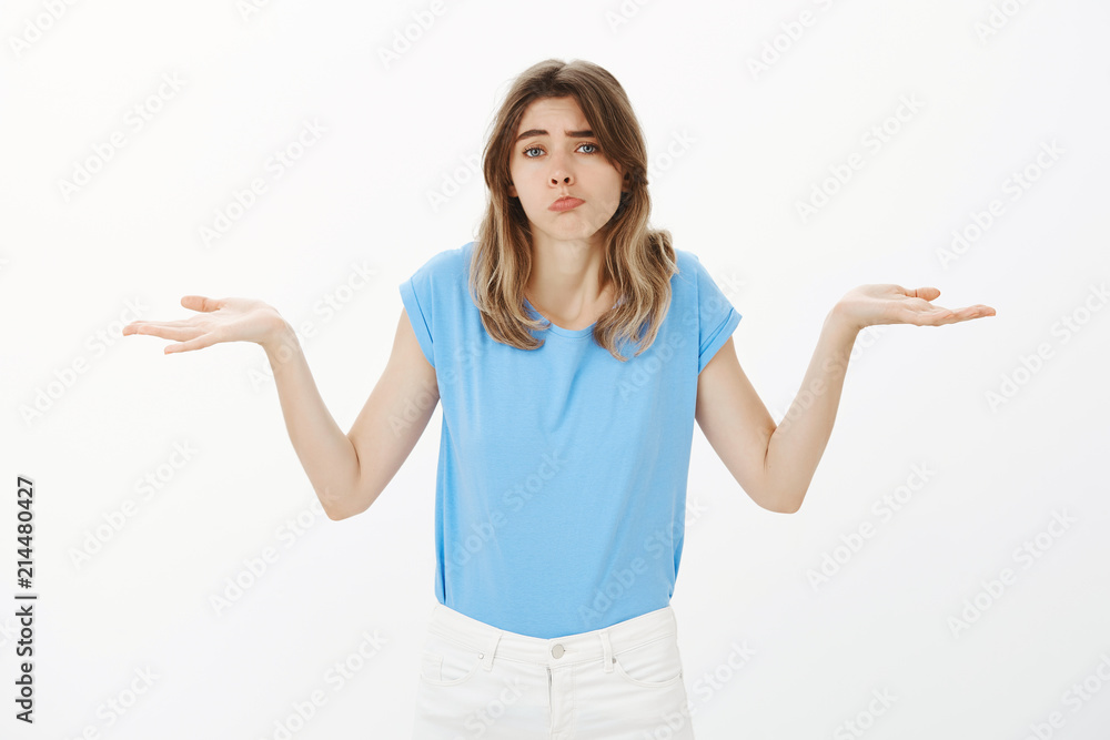 I could not do anything. Portrait of gloomy upset cute woman in casual outfit, shrugging with spread palms, sulking and pouting while frowning, being unaware and helpless, posing over gray wall I could not do anything. Portrait of gloomy upset cute woman in casual outfit, shrugging with spread palms, sulking and pouting while frowning, being unaware and helpless, posing over gray wall