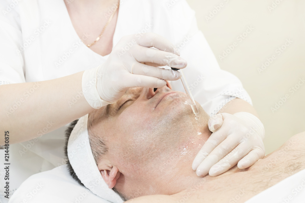 Man in the mask cosmetic procedure in spa salon Man in the mask cosmetic procedure in spa salon