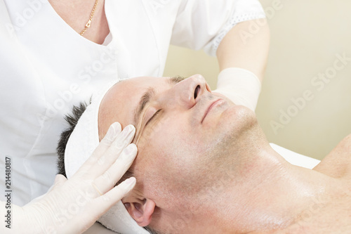 Man in the mask cosmetic procedure in spa salon 