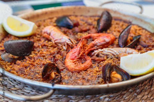 paella in Spanish with seafood and rice in a pan
